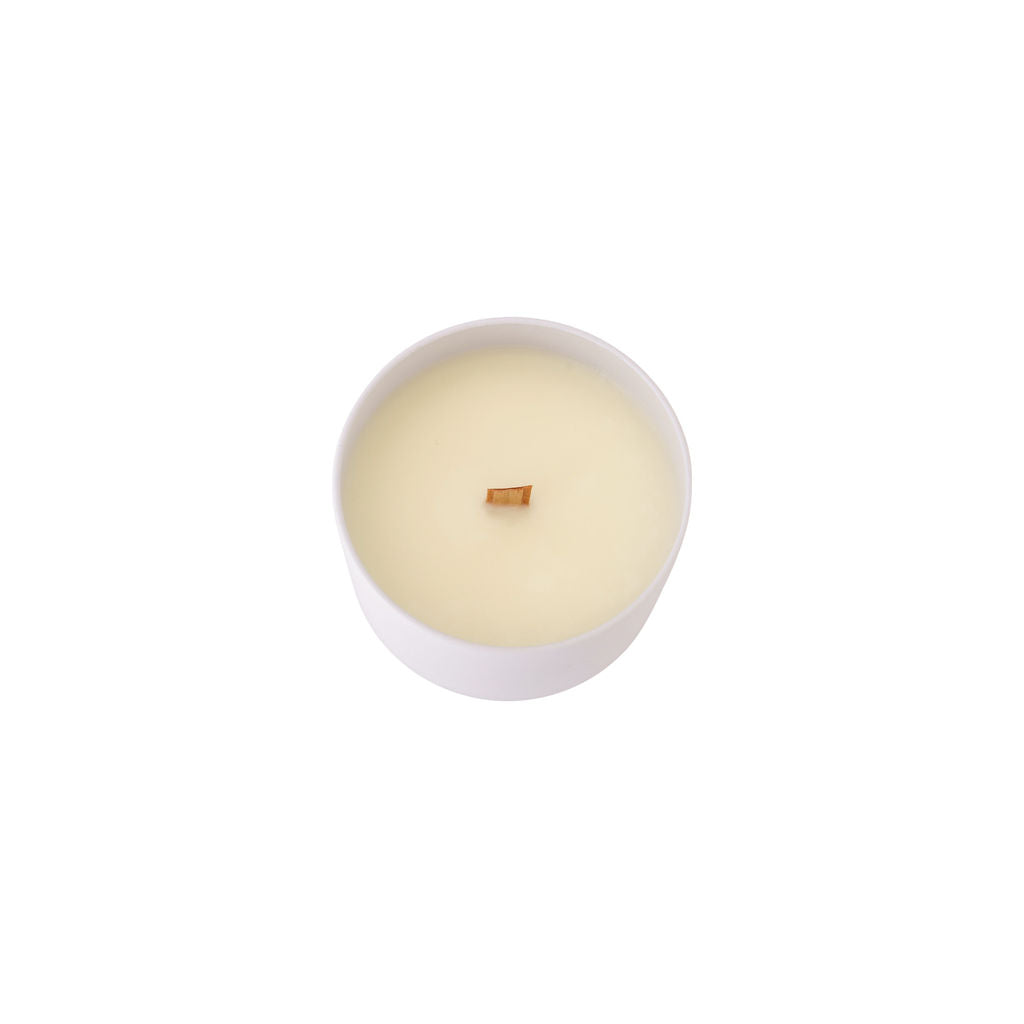 Top view of travel tin candle with smooth coconut soy wax and minimalist label, perfect for travel or gifting.